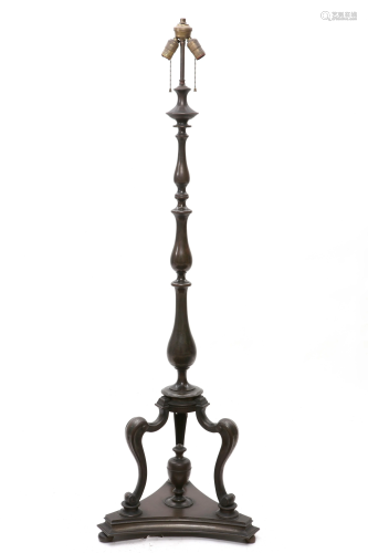 A patinated bronze floor lamp