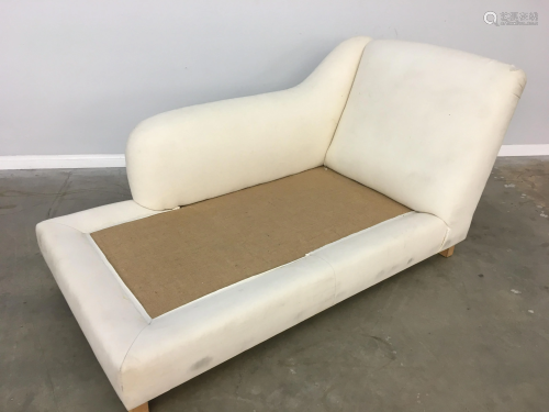 An upholstered chaise lounge