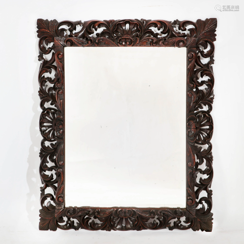A Continental Baroque style carved oak mirror