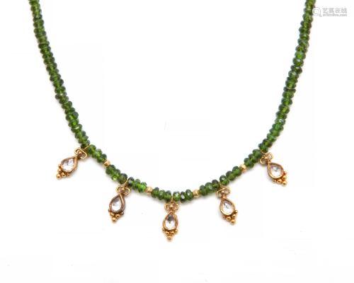 A peridot bead and gold necklace