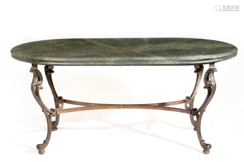 A Rococo style iron and granite dining table