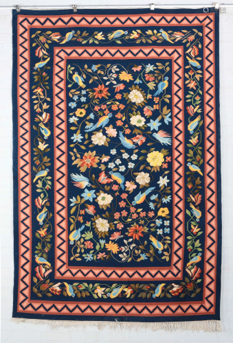 A needlepoint carpet depicting birds