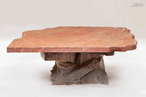 A composition faux stone low occasional table