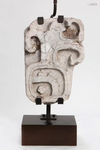 A Mesoamerican carved stone fragment as a lamp