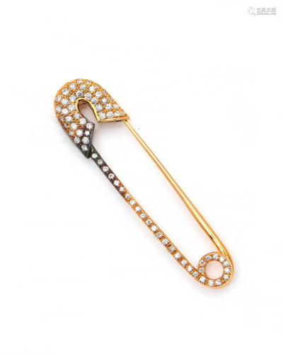 A diamond and 14k gold safety pin