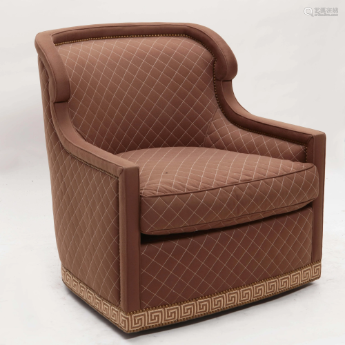 A contemporary upholstered revolving armchair