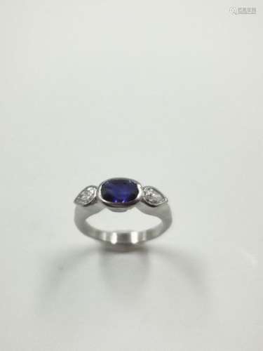 18k white gold ring set with an oval sapphire surr…