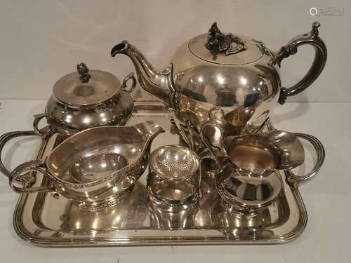 A silver plated metal tray including teapot, sugar…