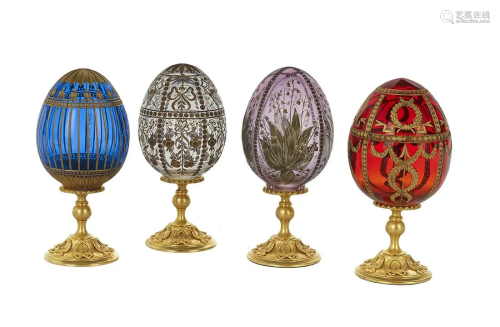 Four Engraved and Cut Crystal Eggs on Stands