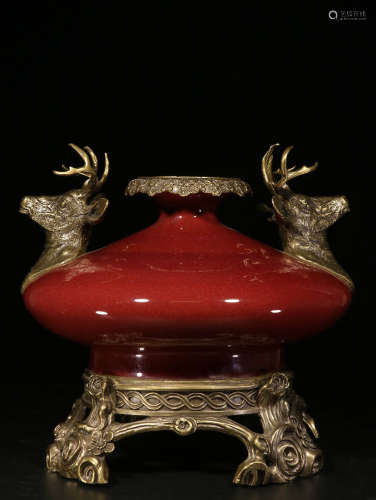 MONOCHROME RED GLAZED AND BRONZE COVERED VASE WITH DEER MASK HANDLES
