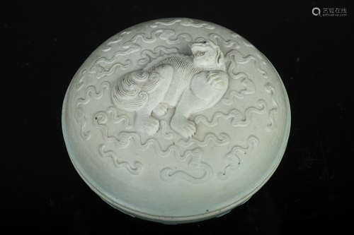 CELADON GLAZED AND CARVED 'MYTHICAL LION' BOX WITH COVER