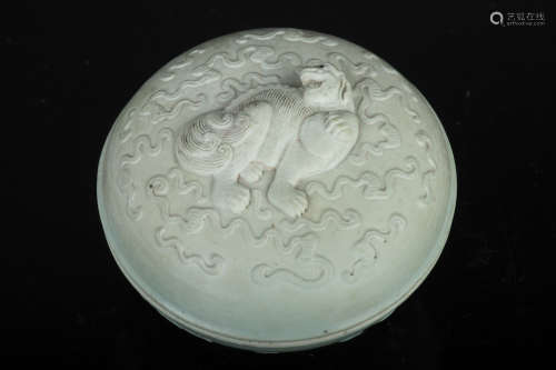 CELADON GLAZED AND CARVED 'MYTHICAL LION' BOX WITH COVER