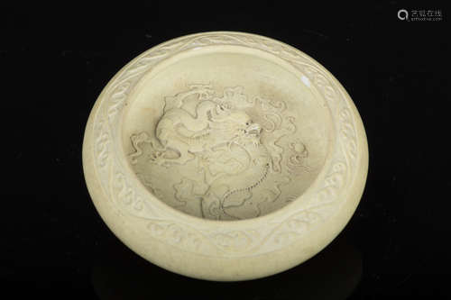 CELADON GLAZED AND CARVED 'DRAGON' COMPRESSED WASHER