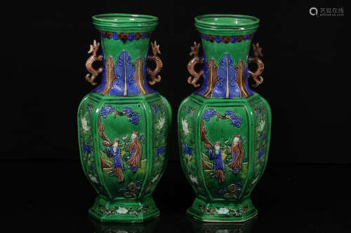 PAIR OF GREEN GLAZED AND CARVED 'PEOPLE' HEXAGONAL VASES