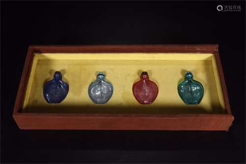 A Set of Four Chinese Peking Glass Snuff Bottles