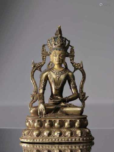 BUDDHA AKSHOBHYABronze with copper inlaysTibet , 14th centuryDimensions: Height 24 cmWeight: 926