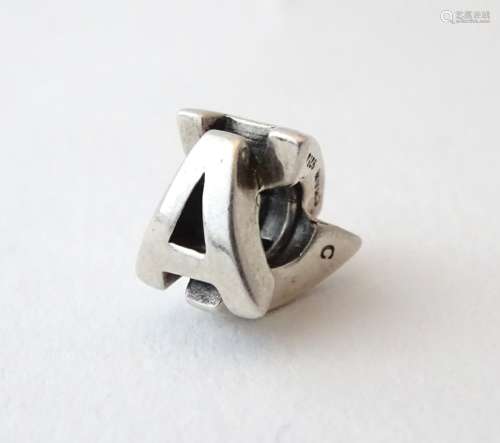 A silver charm of bead form formed as the letters 'A' CONDITION: Please Note - we