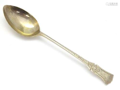 A silver teaspoon with engraved decoration. Hallmarked Sheffield 1907 maker John Sanderson.