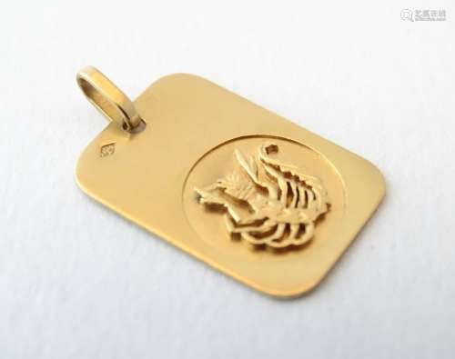 A French 18ct gold zodiac pendant decorated with a stylised scorpion 7/8