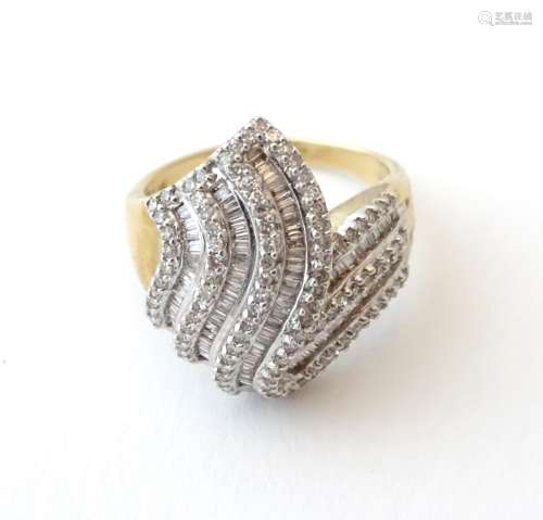 A 9ct gold dress ring set with a profusion of brilliant and baguette cut diamonds. Ring size approx.