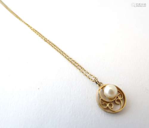 A 9ct gold pendant and chain, the pendant of circular form set with central pearl.