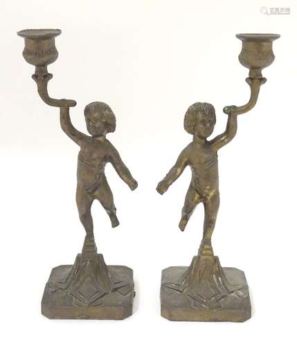 A pair of cast figural candlesticks. Approx.