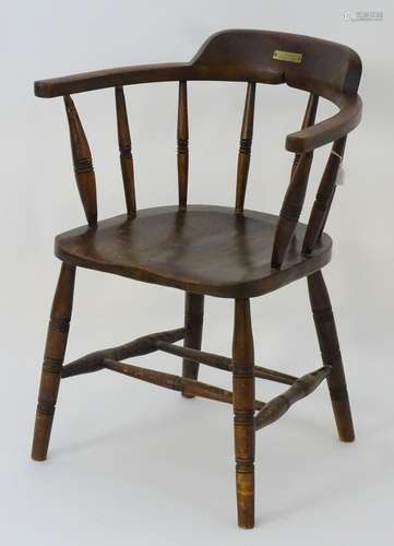 A late 19thC smokers bow chair with ring turned supports and standing on legs united by a double