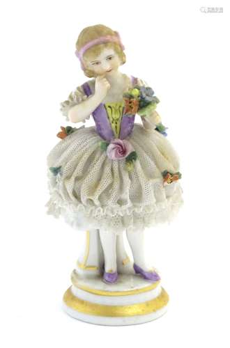 A German porcelain figure of a flower girl with a porcelain lace skirt on a circular base with gilt