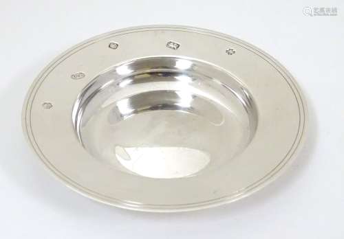 A small silver model of an Armada dish.