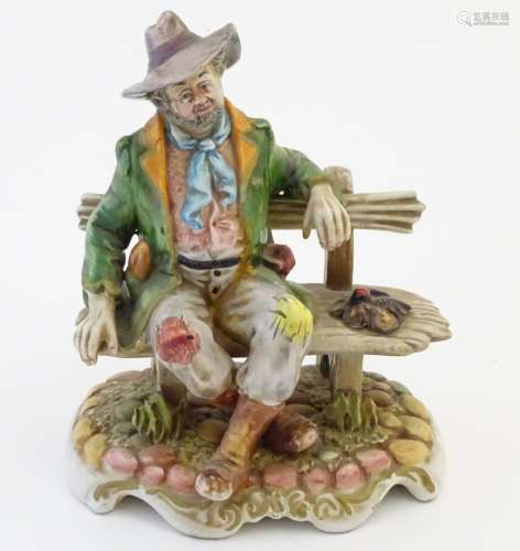 A Capodimonte figure modelled as a tramp wearing a hat on a bench.