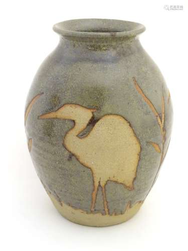 A studio pottery glazed vase of ovoid form with a flare rim, with unglazed,