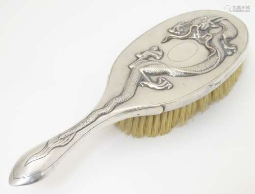 Chinese Export silver : A Chinese white metal backed brush with dragon decoration and marked with
