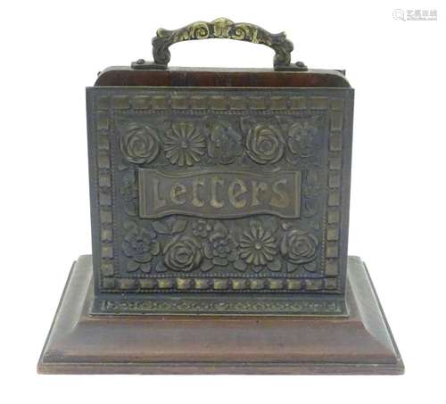 A wooden and brass two sectional letter rack with floral decoration and a banded border. Approx.