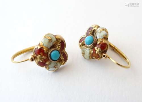 A pair of gold drop earrings set with central turquoise and decorated with red and white enamel