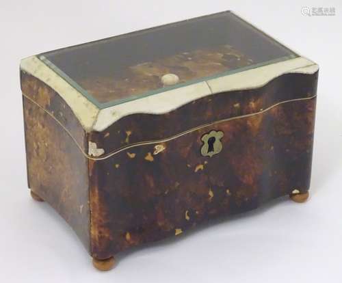 A 19thC tortoiseshell and faux tortoiseshell box / caddy of shaped form with a hinged glass topped