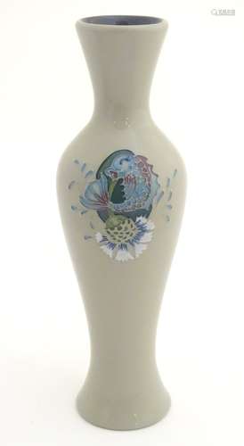 A Moorcroft vase in the shape no. 93/12 decorated with a fish and thistle design.