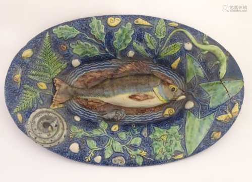 A Palissy ware majolica dish of oval form with applied decoration of a central perch fish