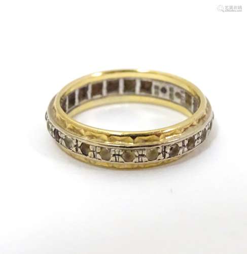 An 18ct yellow and white gold eternity ring set with band of diamonds. Ring size approx.