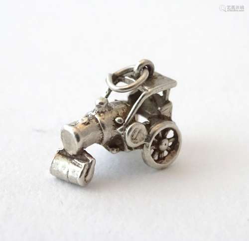 A novelty white metal charm formed as vintage steam roller.