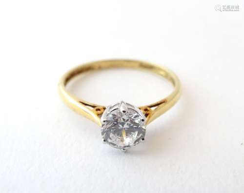 An 18ct gold ring set with a cubic zirconia solitaire. Ring size approx.