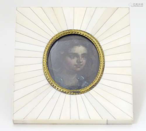 A late 19thC oil on board oval miniature portrait of a young girl. Image approx.