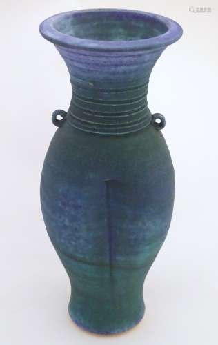 A 20thC studio pottery barium glaze vase by Simon Shaw, with a bulbous body and a flared rim,