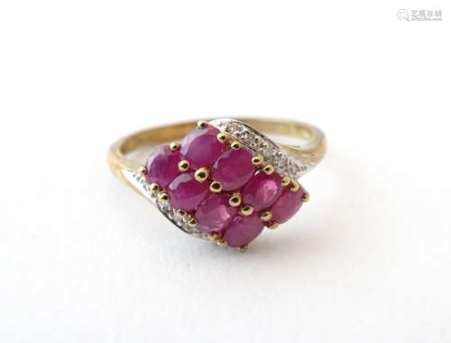 A 9ct gold ring set with 8 red spinel flanked by chip set diamonds. Ring size approx.