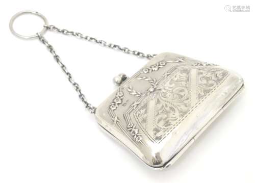 A silver purse with embossed and engraved decoration. Hallmarked Birmingham 1919 maker F D Long.
