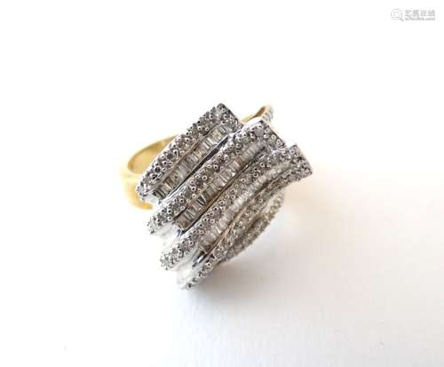 A 9ct gold dress ring set with a profusion of brilliant and baguette cut diamonds. Rind size approx.