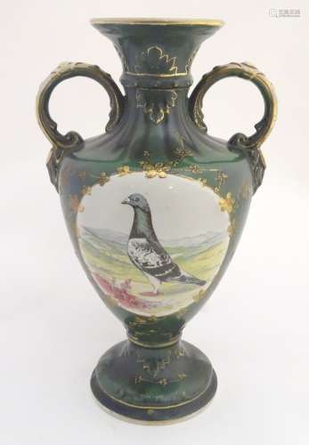 A 20thC baluster vase with a bulbous body, flared foot and rim and twin loop handles.