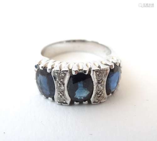 An 18ct white gold ring set with 3 oval sapphires and six diamonds. Ring size approx.