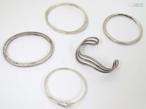 Five assorted silver and silver plate bangle formed bracelets,