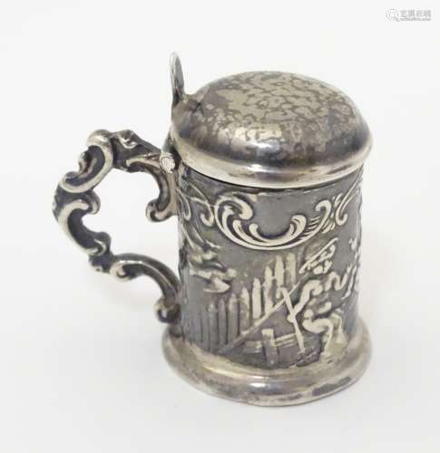 A novelty miniature Continental silver pill box formed as a lidded tankard with cast putti