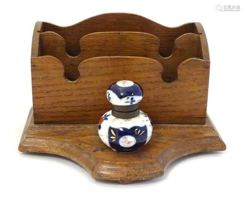 A 19thC wooden letter rack and standish with a pen rest and Imari style ceramic inkwell with floral